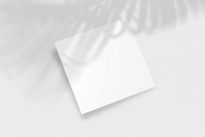 Realistic top view cover square A4 or A5 magazine or brochure booklet for stationery and branding. Mockup template with isolated on light palm leaf shadow overlay. 3D Rendering to place your design. photo