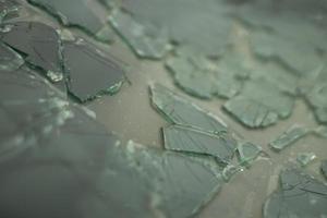 Broken glass in detail. Car windshield after the accident. Lots of small pieces. photo