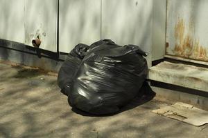 Garbage in bags. Black bags of waste. Plastic bags. photo