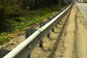 Bumper along the road. Fence for vehicles. photo