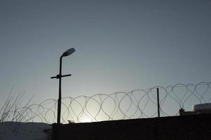 Barbed wire fence. Fencing of industrial zone. Territory is protected. photo