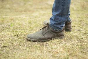 Leather boots and blue jeans. Classic fashion. photo