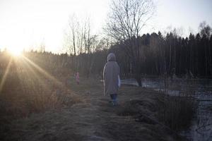 A girl walks with a child. photo