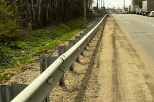 Bumper along the road. Fence for vehicles. photo