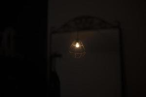 A lamp in a dark room. The gloomy lighting of the room. photo