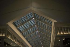 The roof is made of glass. Ceiling with evening light. Natural lighting in a large room. photo