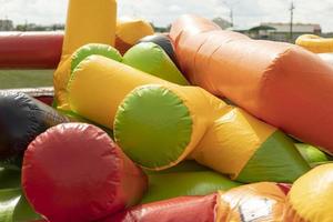 Deflate obstacle course in amusement park. Air escapes from inflatable structure. Details of collection of attractions. photo