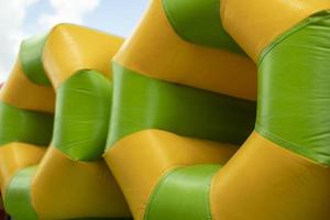 Inflatable pipe on playground. Obstacle course in amusement park. photo