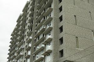 Windows of the house under construction. Construction of a building in the city. Construction of an apartment building. The building is unlined. photo