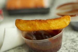 Potatoes with sauce. Food with ketchup. Fried potatoes for lunch. photo