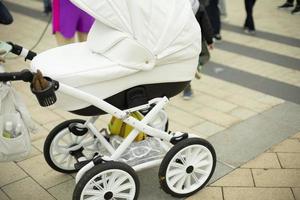 Children's stroller for walks. White cart for rolling the child. photo