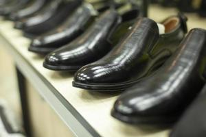 Black shoes in the store. Shoes are in a row. Lacquered shoes on sale. photo