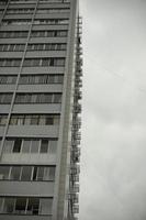 Tall building with windows and balconies. Urban development in the 21st century. Architecture of the 20th century in the Soviet Union. photo