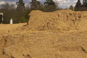 Sand platform. Laying sand in the base. A lot of building material. photo