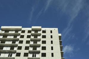 Unfinished building. House without cladding. Window openings without window frames. photo