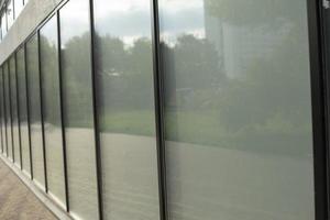 Facade glass in a long house. A row of window frames. photo