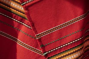 Red tablecloth in Russia. Folk pattern on the fabric. Fabric material in the Slavic peoples. photo