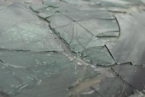 Broken glass in detail. Car windshield after the accident. Lots of small pieces. photo