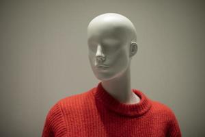 Mannequin in a red sweater. Shop window. Wool-bound clothing. photo