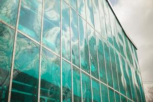 Blue glass building and sky. Panoramic windows. Reflection. photo