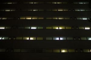 Windows in building at night. Unique architecture. photo