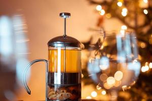 Teapot french press with green tea and tangerine slices photo