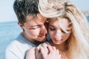 Close-up of guy hugging her girlfriend photo