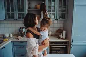 Happy family having fun in the kitchen photo