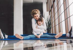 Mother and daughter hugs and stretch in the gym photo