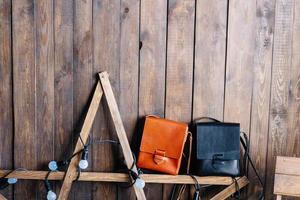 two leather bags on a wooden background photo