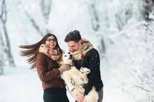 Young couple having fun in winter park photo