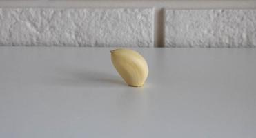 Garlic clove isolated on a white kitchen table background photo