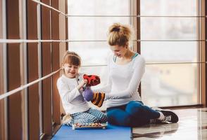 Mother and daughter playing with toys in the gym photo