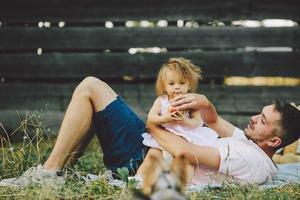 Happy family on lawn in the park photo