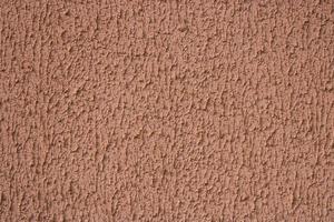 Textured background. Decorative plaster walls, external decoration of facade. Texture of beige photo