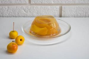 Peach jelly with peach slices, isolated on a white background photo
