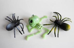 Halloween background with two spiders and a skeleton on a white background. Happy Halloween concept photo
