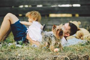 Happy family on lawn in the park photo