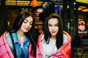 two close friends watching something on a tablet photo