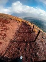 A mountain path bordered by red cliffs photo