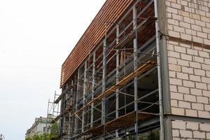 Modern building is under construction, metal scaffolding photo