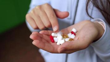 Vitamins and medication in woman hands video