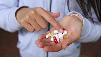 Vitamins and medication in woman hands