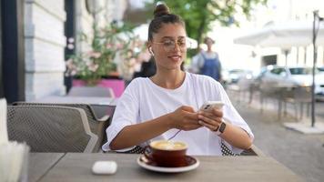 Beautiful woman at cafe outdoor table video