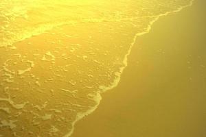 Shiny gold beach texture,abstract background,golden pattern photo