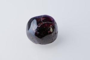 garnet gemstone against white background photo