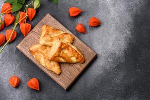 Delicious fresh cornmeal pastries with homemade cheese on a wooden cutting board photo