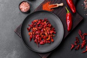 Pieces of dried paprika, preparation of powder spice for various dishes photo