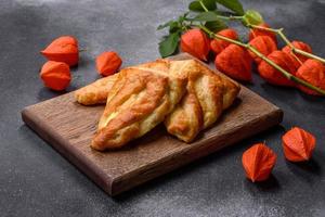 Delicious fresh cornmeal pastries with homemade cheese on a wooden cutting board photo