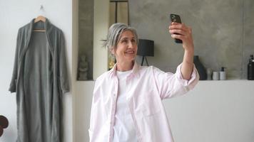 Woman taking selfie at home video